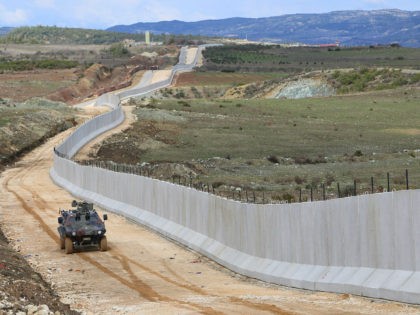 HATAY, TURKEY - FEBRUARY 22: Turkish security forces patrol with an armored vehicle as 35 kilometres long, 3 metres high and 7 tones weighted concrete wall, builded in order to prevent illegal border crossing and smuggling, is seen on the Turkey - Syria border, in Hatay, Turkey on February 22, …
