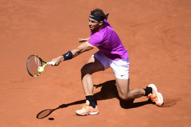 Spanish tennis player Rafael Nadal returns a ball to Serbian tennis player Novak Djokovic