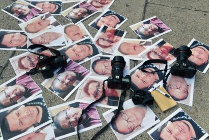 Pictures of journalists recently murdered in different Mexican states lay on the ground at