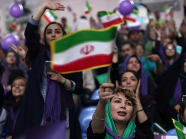Supporters of Iranian President Hassan Rouhani chant slogans during a campaign rally in Zanjan on May 16, 2017. Iran's presidential election is effectively a choice between moderate incumbent Rouhani and hardline jurist Ebrahim Raisi