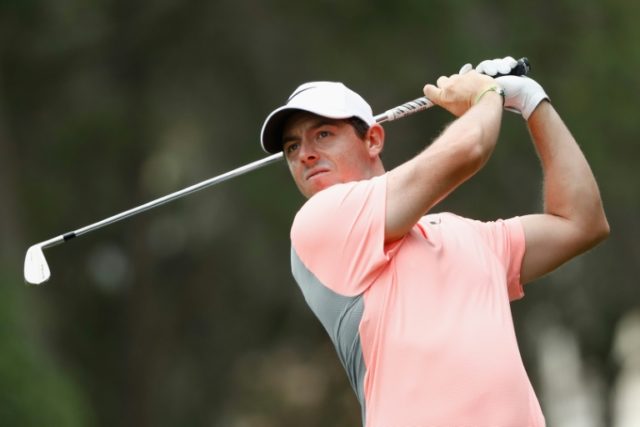 Rory McIlroy of Northern Ireland plays a shot on the first hole during the final round of