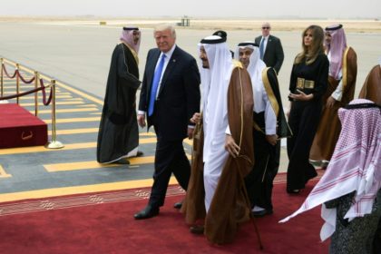 US President Donald Trump (C-L) is welcomed by Saudi King Salman bin Abdulaziz al-Saud (C)
