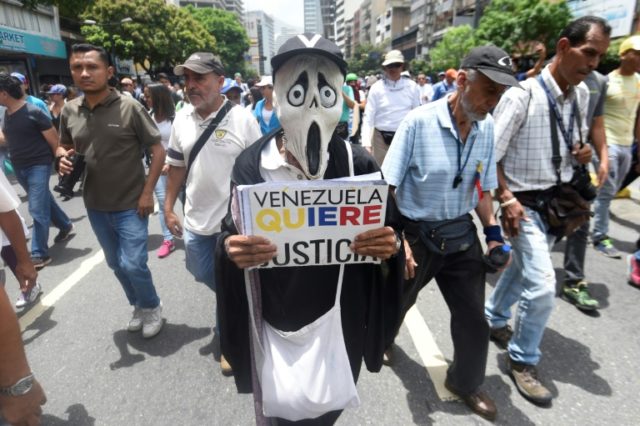 Opposition activists march in Caracas on May 22, 2017