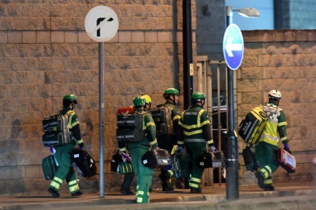 Medics arrive at the scene of the suspected explosion at an Ariana Grande pop concert in M