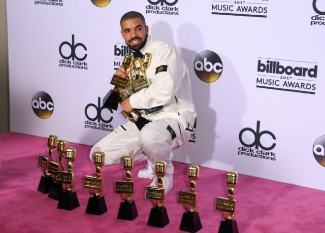 Canadian hip-hop star Drake poses with his trophies after winning a record 13 Billboard Mu