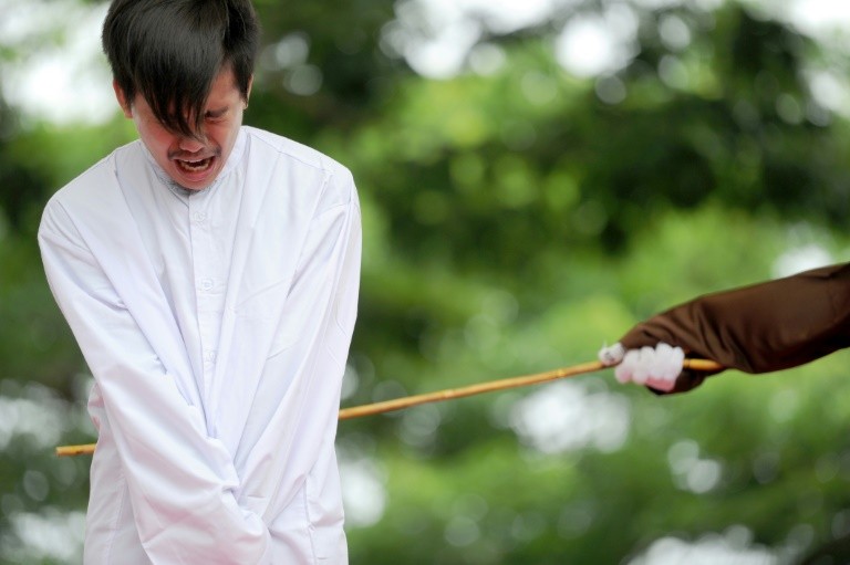 Indonesian Men Caned For Gay Sex Before Jeering Crowd