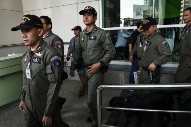 A Thai police forensics team leaves a Bangkok hospital that was struck by a small bomb on