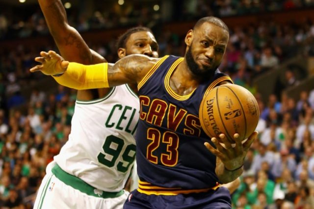 LeBron James of the Cleveland Cavaliers battles for the ball with Jae Crowder of the Bosto