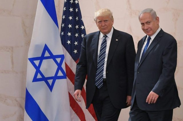 US President Donald Trump walks alongside Israeli Prime Minister Benjamin Netanyahu as he