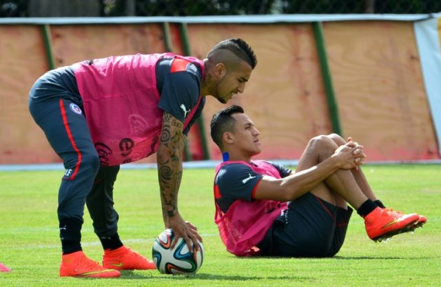 Chile forwards Arturo Vidal (left) and Alexis Sanchez stretch during a 2014 training sessi