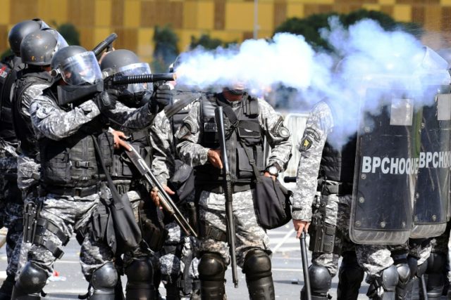 Riot police clash with demonstrators demanding the resignation of embattled President Mich