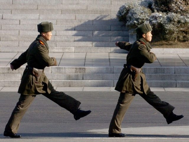 North Korean soldiers march in village of Panmunjom on the Demilitarized Zone (DMZ) dividi