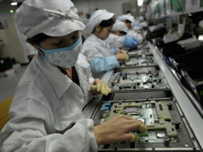 Workers assemble electronic components at a Foxconn factory
