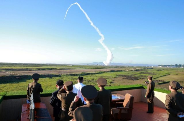 North Korean leader Kim Jong-Un (C-in white shirt) watching the test of a new anti-aircraf