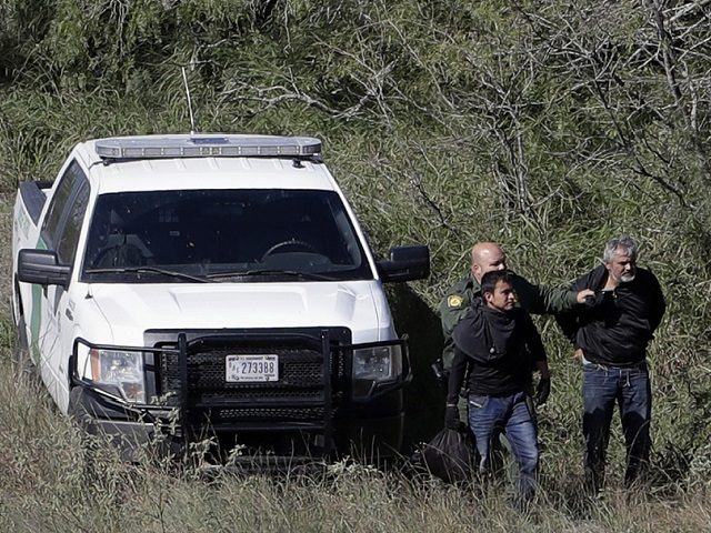 In this Tuesday, Nov. 15, 2016, photo, a U.S. Customs and Border Patrol agents stop a grou