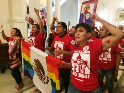 Demonstrators march in the Texas Capitol on Monday, May 29, 2017, protesting the state's newly passed anti-sanctuary cities bill in Austin, Texas. Opponents call Texas' anti-sanctuary cities law a "show your papers" law since it empowers police to inquire about peoples' immigration status during routine interactions such as traffic stops. …
