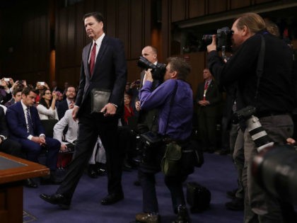Former FBI Director James Comey arrives before testifying to the Senate Intelligence Committee in the Hart Senate Office Building on Capitol Hill June 8, 2017 in Washington, DC. Comey said that President Donald Trump pressured him to drop the FBI's investigation into former National Security Advisor Michael Flynn and demanded …