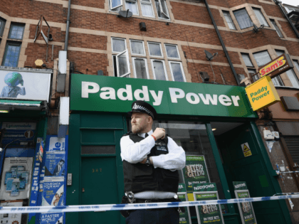 A police officer stands outside a block of flats over shops in East Ham, one of which has been raided by police earlier today on June 4, 2017 in London, England.