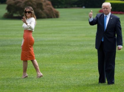 US President Donald Trump (R) gives a thumbs up as he and First Lady Melania Trump (L) dep