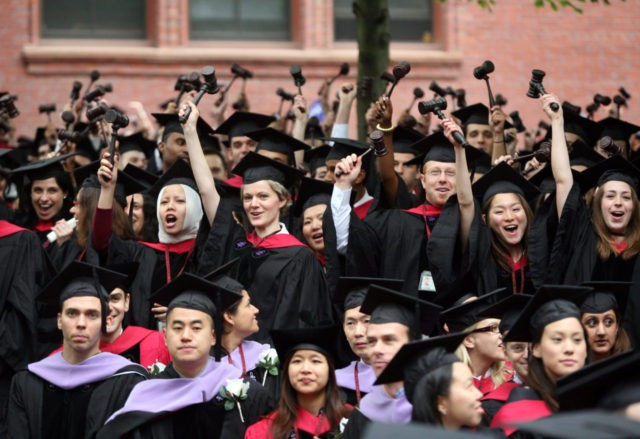 CAMBRIDGE, MA - JUNE 5: Graduating Harvard University Law School students stand and wave g