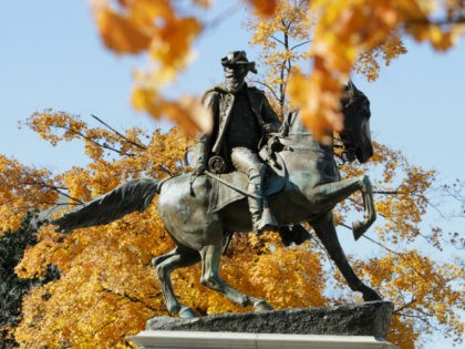 Leaves displaying fall colors frame the statue of Confederate General J.E.B. Stuart on Mon