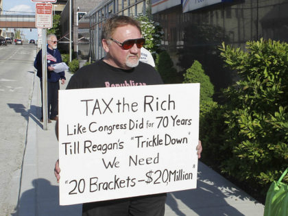 In this undated file photo, James Hodgkinson holds a sign during a protest outside of a Un