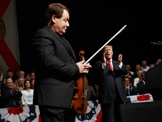 President Donald Trump cheers Cuban born violinist Luis Haza after the playing of the nati