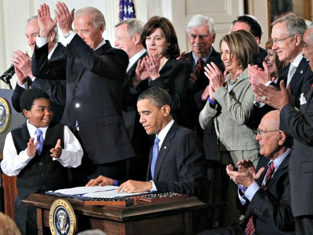 Obama signs Obamacare Charles DharapakAP