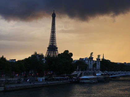 Dark clouds and rain are pictured over Paris and the Eiffel tower at sunset on May 19, 2017. / AFP PHOTO / LUDOVIC MARIN (Photo credit should read LUDOVIC MARIN/AFP/Getty Images)