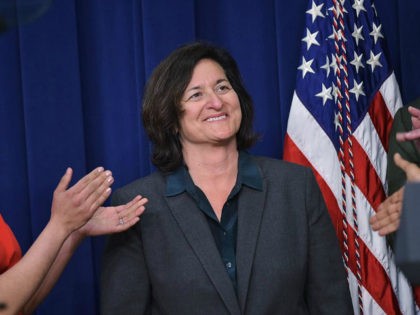 Patagonia CEO Rose Marcario receives applause after being acknowledge by US President Barack Obama during an event highlighting important middle class issues on April 16, 2015 in the South Court Auditorium of the Eisenhower Executive Office Building, next to the White House, in Washington, DC. AFP PHOTO/MANDEL NGAN (Photo credit …