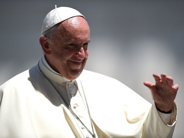 Pope Francis waves during a weekly general audience at St Peter's square on June 21,