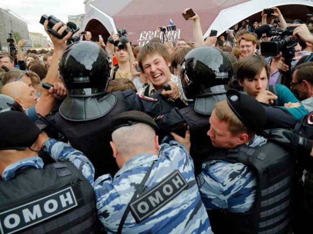 Protestors are blocked by riot police during a demonstration in downtown Moscow, Russia, on Monday.