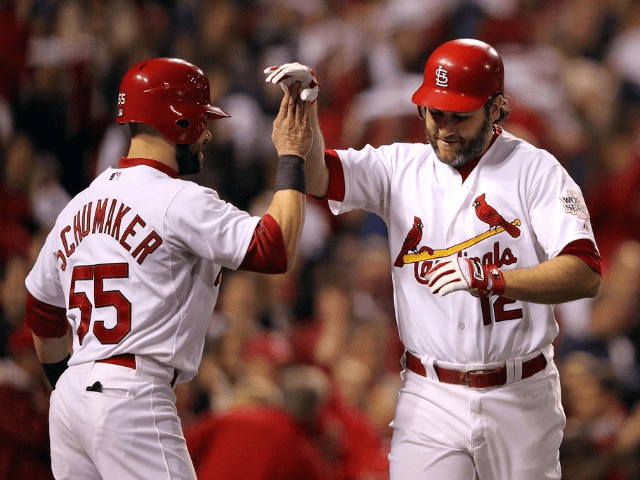 Lance Berkman #12 of the St. Louis Cardinals celebrates with Skip Schumaker #55 after hitting a two-run home run in the first inning during Game Six of the MLB World Series against the Texas Rangers at Busch Stadium on October 27, 2011 in St Louis, Missouri.