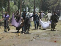 Afghans carry the bodies of men at after a suicide car bombing in Helmand province southern of Kabul, Afghanistan, Thursday, June 22, 2017. The bomber struck outside a bank, targeting Afghan troops and government employees waiting to collect their salaries ahead of a major Muslim holiday and killing at least …