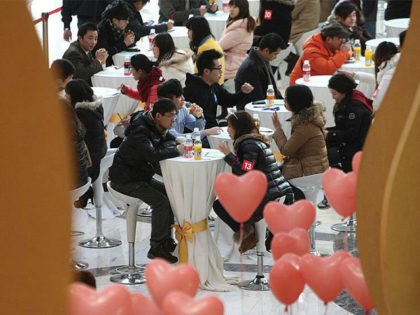 SHANGHAI, CHINA - FEBRUARY 11: (CHINA OUT) Men and women gather during a 'singles fair' as they look for potential partners at Joy City on February 11, 2012 in Shanghai, China. Preparations for Valentine's Day begin around China after the Spring Festival. (Photo by VCG/VCG via Getty Images)