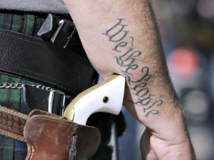 FILE - In this Jan. 26, 2015 file photo, a supporter of open carry gun laws, wears a pistol as he prepares for a rally in support of open carry gun laws at the Capitol, in Austin, Texas. Texas is still sorting out where firearms are allowed, and where they're …