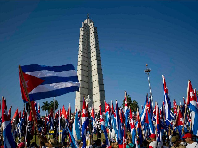 People march with Cuban flags during the May Day parade at Revolution Square in Havana, Cuba, Monday, May 1, 2017. (AP Photo/Ramon Espinosa)