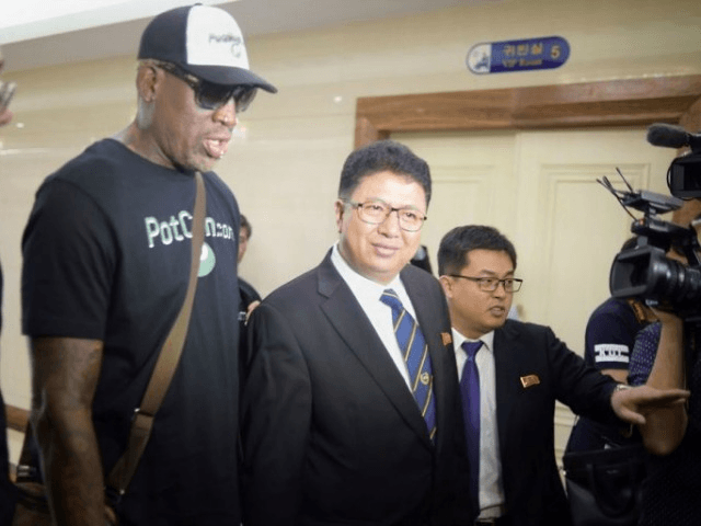 Flamboyant former NBA star Dennis Rodman (2nd L) of the US talks with Son Gwang-Ho (C), No