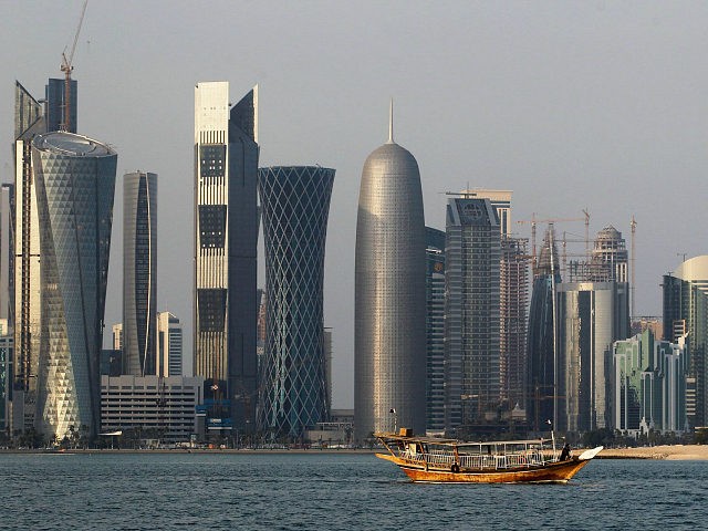 FILE - In this Thursday Jan. 6, 2011 file photo, a traditional dhow floats in the Corniche Bay of Doha, Qatar, with tall buildings of the financial district in the background. Qatar, now facing a diplomatic crisis with other Arab nations, is a small country with a big history of …