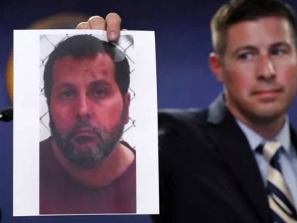 Timothy Wiley, FBI public affairs specialist, holds a photo Amor Ftouhi after a news conference in Detroit, Thursday, June 22, 2017. Amor Ftouhi, a Canadian man, shouted in Arabic before stabbing a police officer in the neck at the Bishop International Airport in Flint, Mich., on Wednesday, and referenced people …