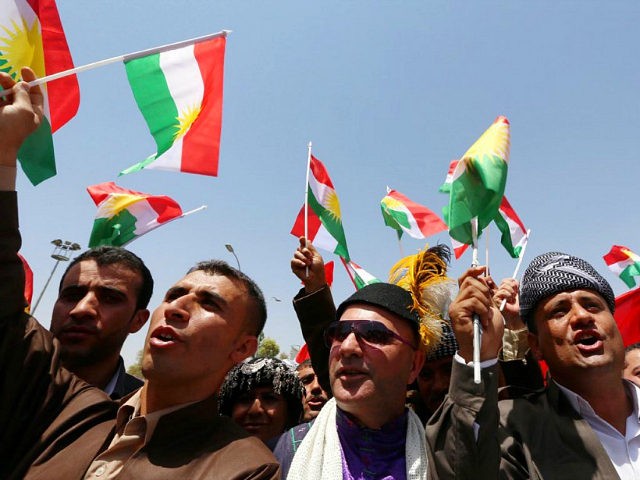 Iraqi Kurds protest and wave flags of their autonomous Kurdistan region during a demonstration to claim for its independence on July 3, 2014 outside the Kurdistan parliament building in Arbil, in northern Iraq. The Kurdish leader, Massud Barzani asked its parliament to start organizing a referendum on independence. AFP PHOTO …