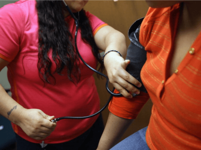 AURORA, CO - MARCH 27: A medical assistant checks a patient's blood pressure at a communit