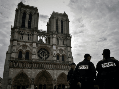 French soldiers stands guard in front of the Notre-Dame Cathedral in Paris on April 14, 2017, as worshippers and tourist arrive at the cathedral on Good Friday, the start of the Christian Easter celebrations.