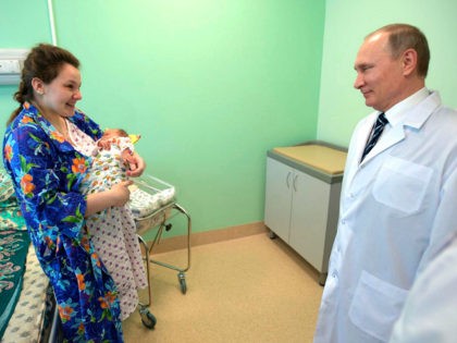BRYANSK, RUSSIA - MARCH 8, 2017: Russia's President Vladimir Putin (R) meets a young mother on his visit to a new cutting-edge perinatal centre. Alexei Druzhinin/Russian Presidential Press and Information Office/TASS (Photo by Alexei Druzhinin\TASS via Getty Images)