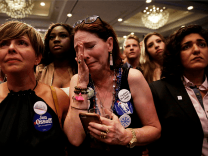 Supporter Jan Yanes, center, cries as Democratic candidate for 6th congressional district Jon Ossoff concedes to Republican Karen Handel at his election night party in Atlanta, Tuesday, June 20, 2017. (AP Photo/David Goldman)