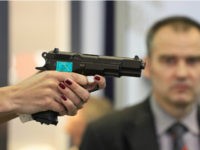 A woman's hand holds a CZ 75 semi-automatic pistol at the booth of Czech firearm producer Ceska Zbrojovka during the International Exhibition of Defence and Security Technologies (IDET) in Brno, Czech Republic on May 22, 2013. The IDET, on of the biggest fairs for defence technology opened on May 22 …