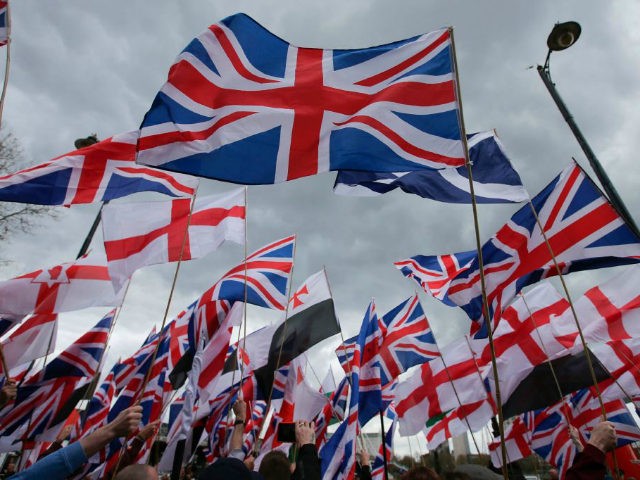 Supporters of the far-right group Britain First wave flags as they march and rally in central London on April 1, 2017 following the March 22 terror attack on the British parliament. Members of the Britain First group and the English Defence League rallied in central London in on seperate marches …