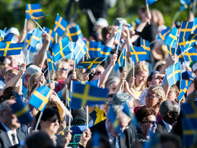STOCKHOLM, SWEDEN - JUNE 06: Spectators wave the Swedish flag during the national day celebrations at Skansen on June 6, 2017 in Stockholm, Sweden. (Photo by Michael Campanella/Getty Images)