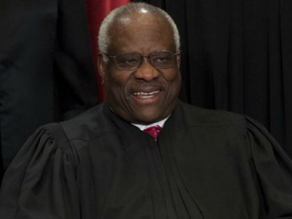 US Supreme Court Associate Justice Clarence Thomas sits for an official photo with other m
