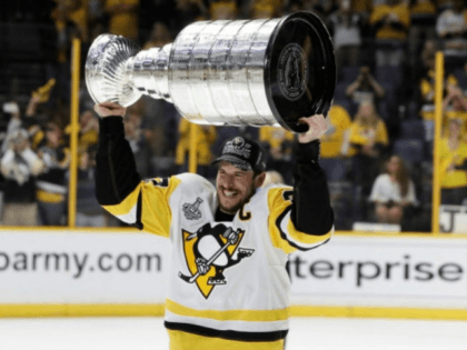 Pittsburgh Penguins’ Sidney Crosby (87) celebrates with the Stanley Cup after defeating